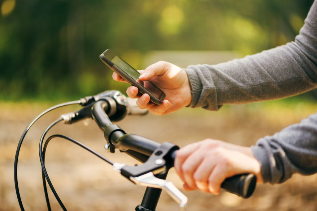 自転車に乗っている間にテキストメッセージを入力する女性